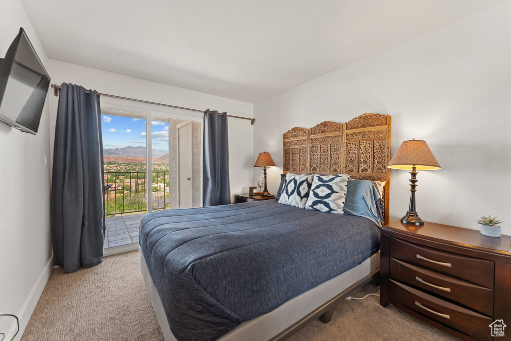 Bedroom featuring access to outside, carpet floors, and baseboards