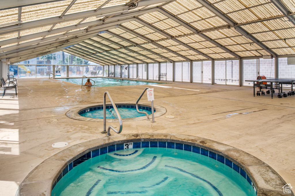 View of pool with an indoor in ground hot tub