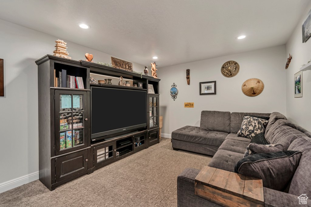 Carpeted living room with baseboards and recessed lighting