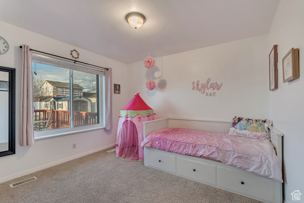 Bedroom with baseboards, carpet floors, and visible vents