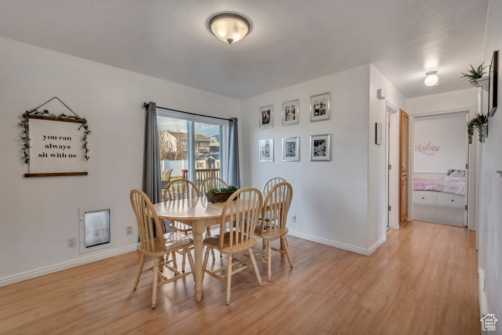 Dining room featuring baseboards and light wood finished floors