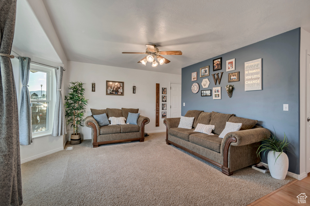 Living area with baseboards and ceiling fan
