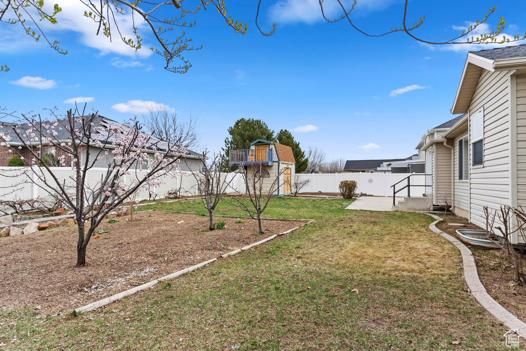 View of yard featuring a fenced backyard, a patio area, and a garden