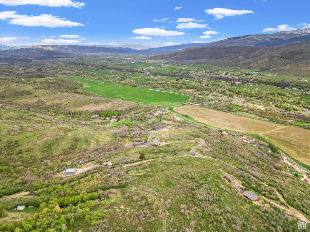 Aerial view of property's location featuring a mountain backdrop