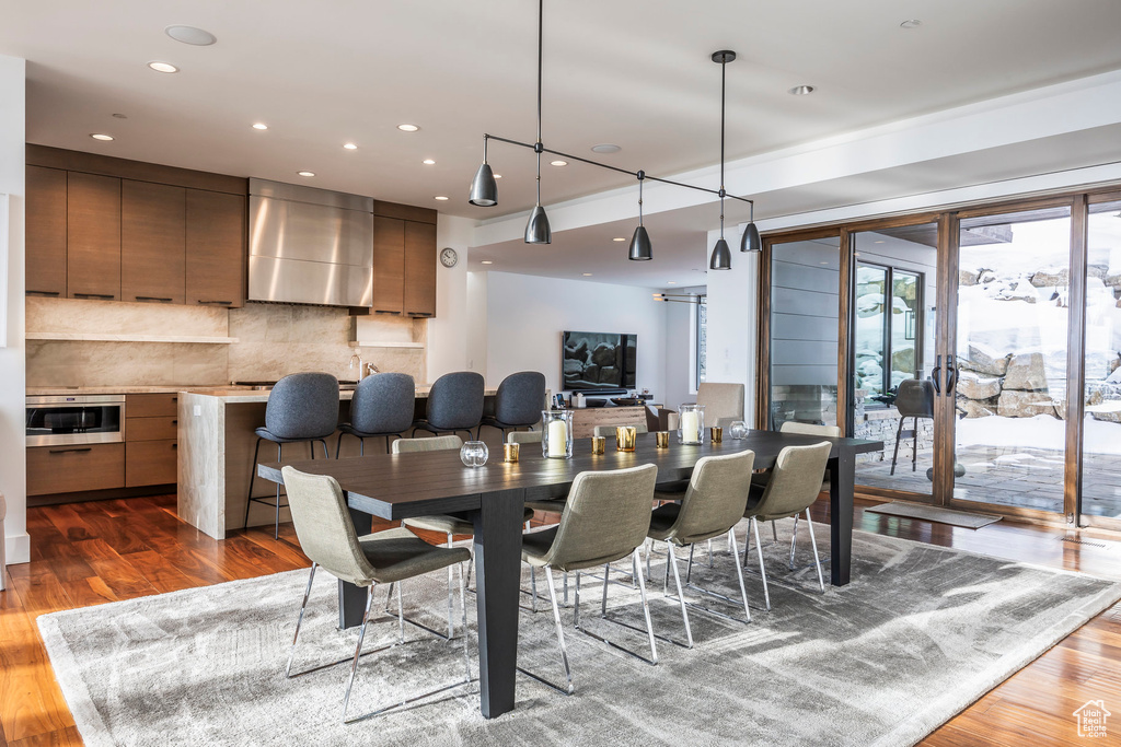 Dining space featuring wood finished floors and recessed lighting