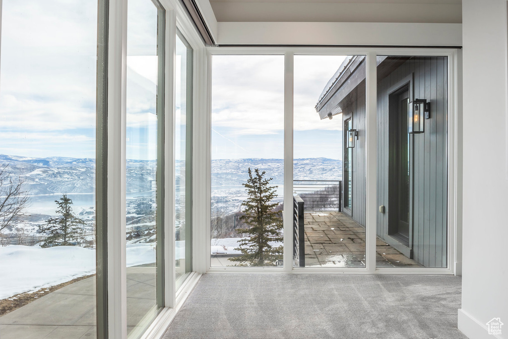 Unfurnished sunroom featuring a mountain view