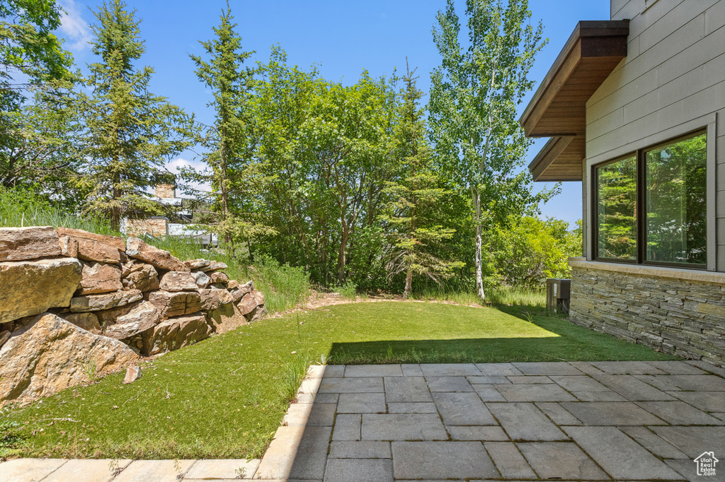 View of green lawn with a patio