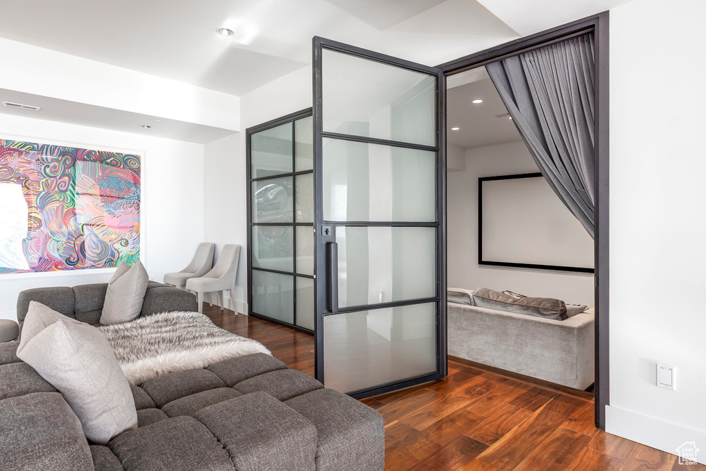 Living area featuring dark wood-type flooring and baseboards