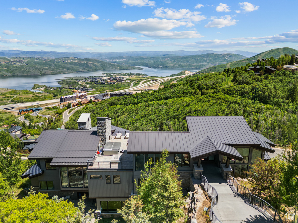 Bird\'s eye view of a water and mountain view and a heavily wooded area
