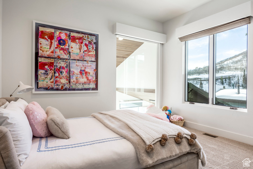 Bedroom featuring carpet floors and baseboards