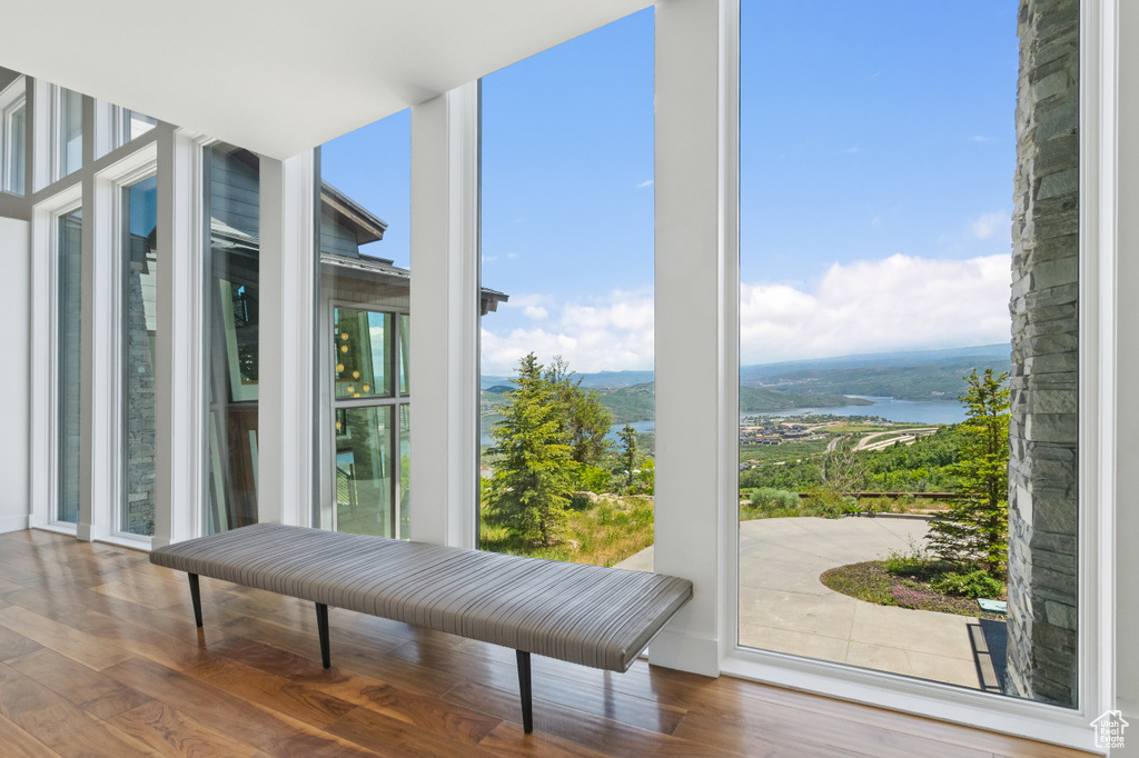 Interior space with a wall of windows, wood finished floors, and a mountain view