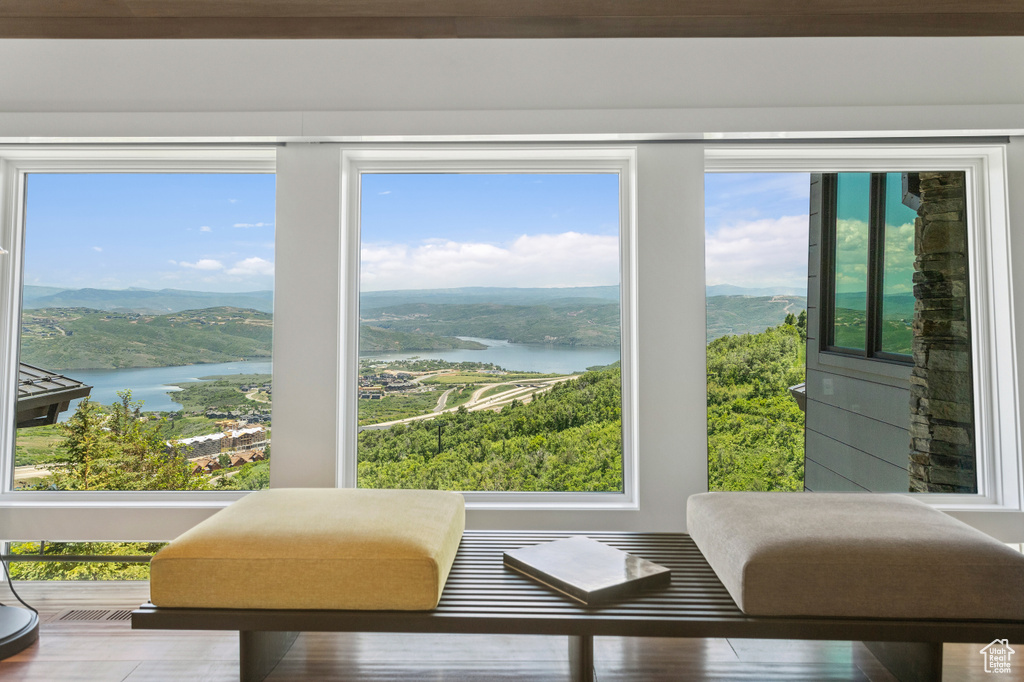 Sunroom / solarium with a water and mountain view