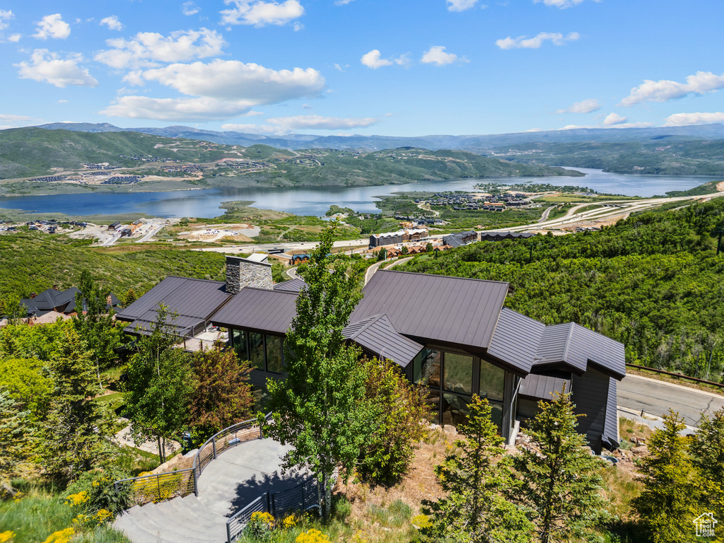 Drone / aerial view of a water and mountain view and a heavily wooded area