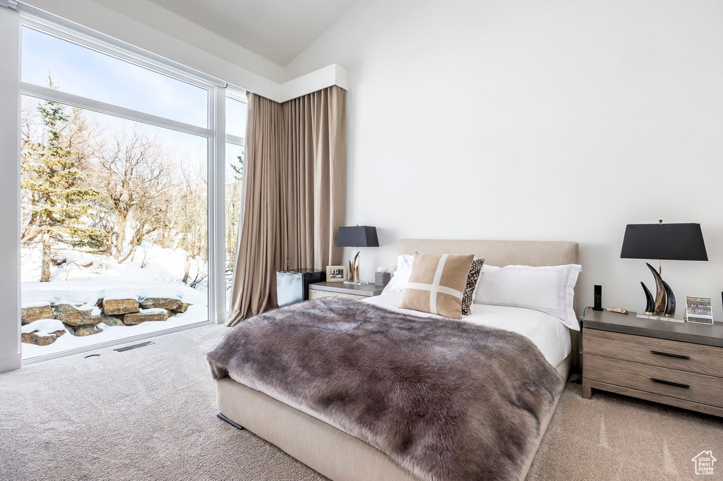 Bedroom featuring carpet flooring, access to outside, and vaulted ceiling