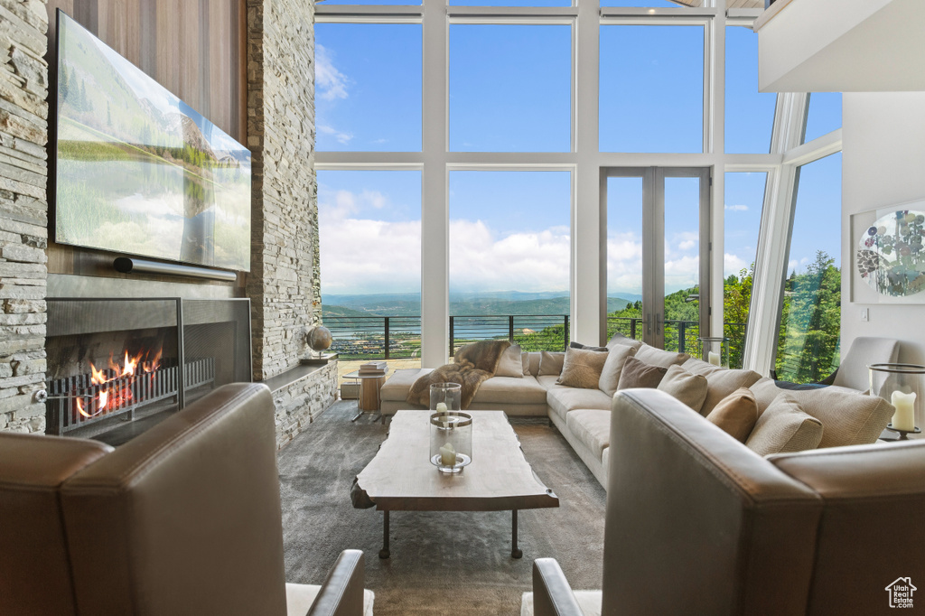 Living area featuring a fireplace and a towering ceiling
