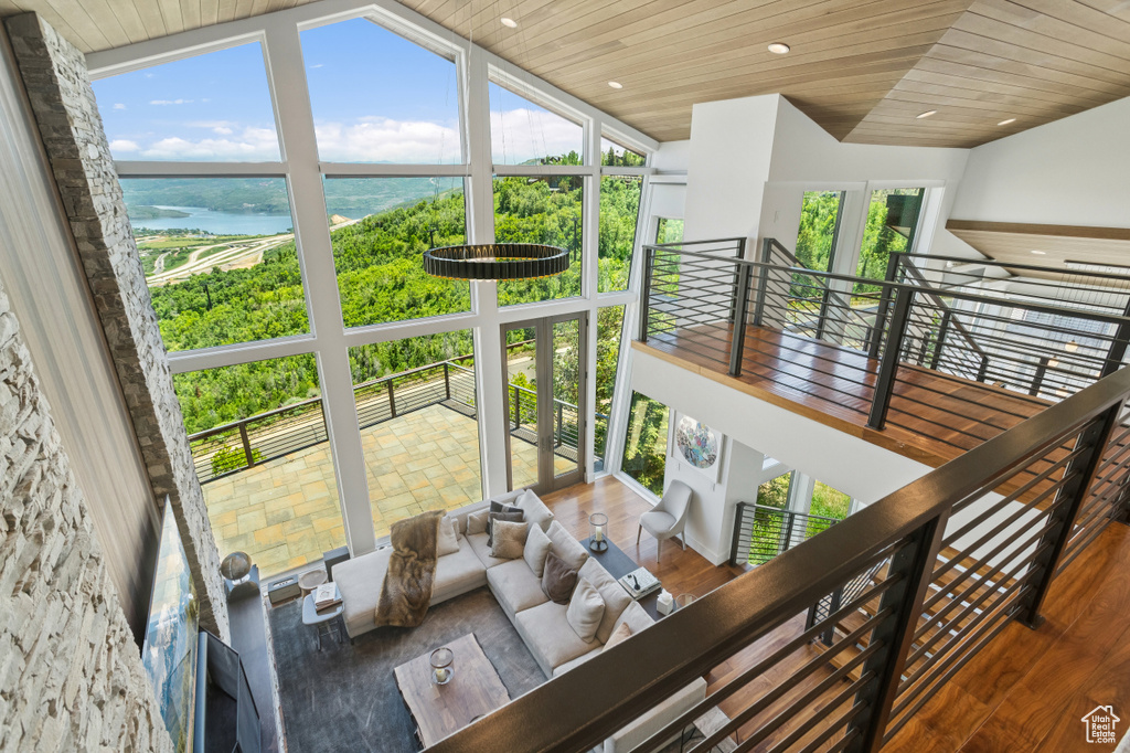 Stairway featuring wooden ceiling, vaulted ceiling, wood finished floors, and recessed lighting