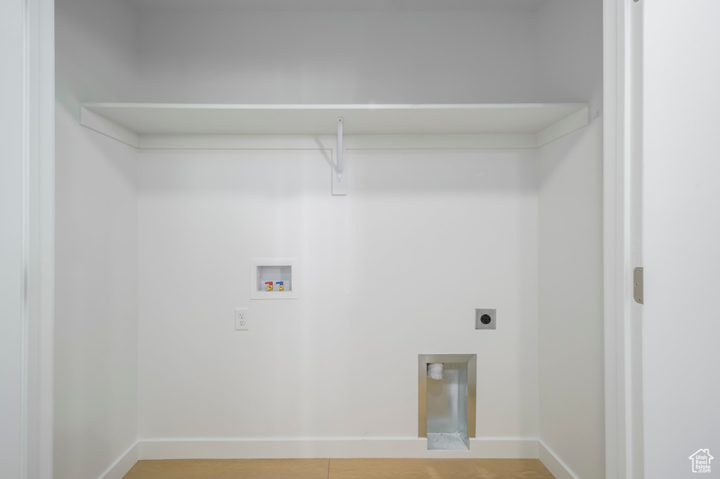 Washroom with baseboards, washer hookup, laundry area, and electric dryer hookup