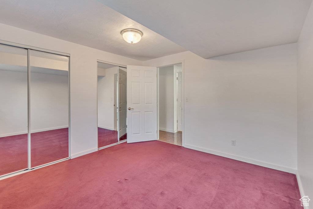Unfurnished bedroom with baseboards and carpet flooring