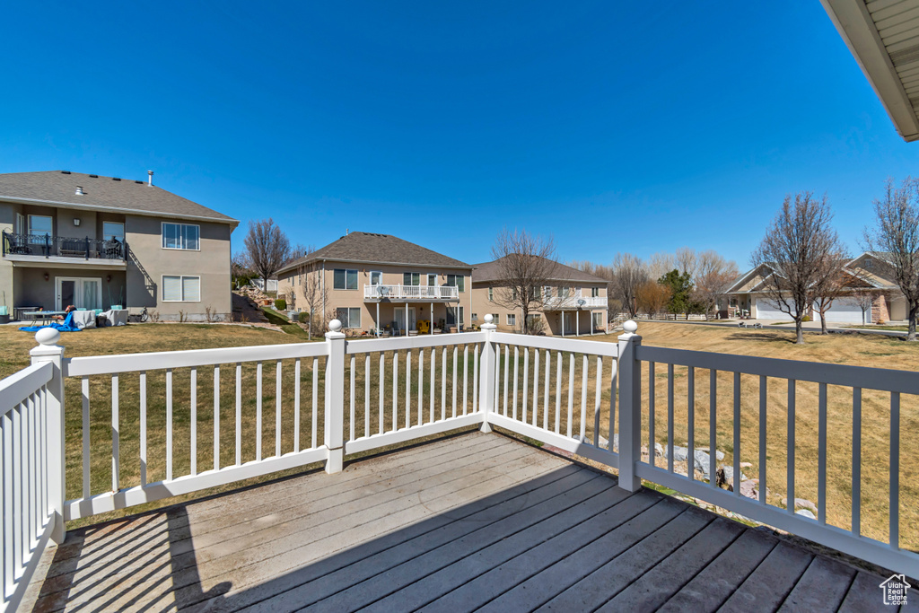 Wooden terrace with a yard and a residential view