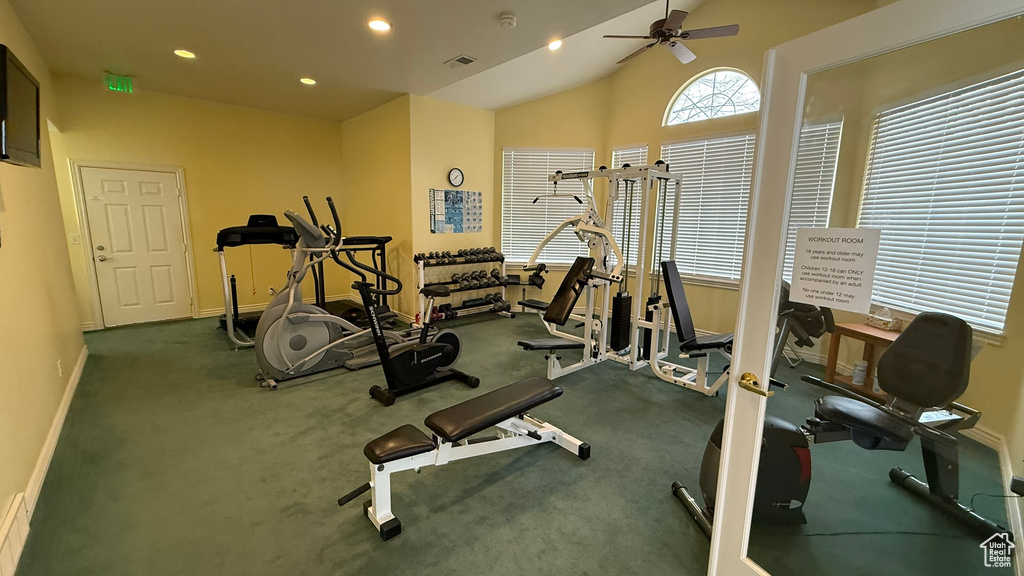 Gym with baseboards, lofted ceiling, recessed lighting, and a ceiling fan