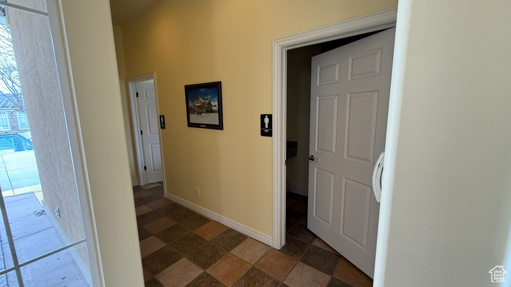 Hall with baseboards and stone finish flooring