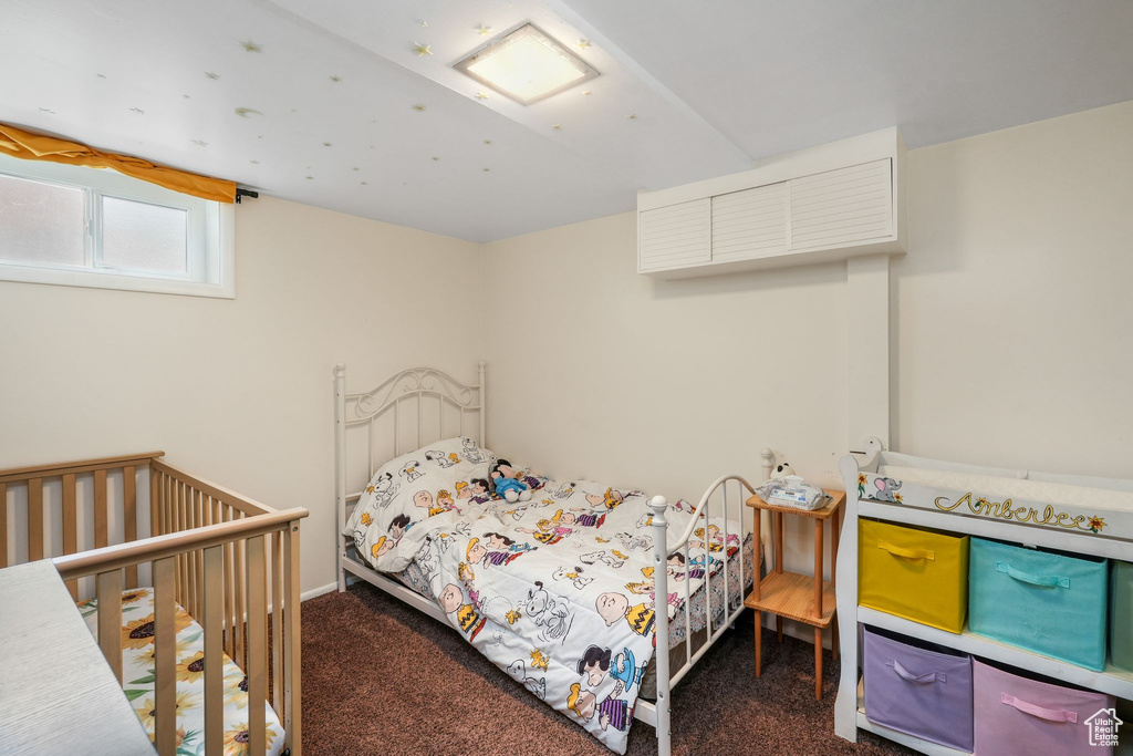 Bedroom featuring dark carpet