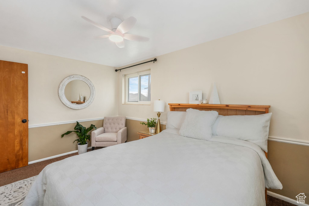 Carpeted bedroom with baseboards and ceiling fan