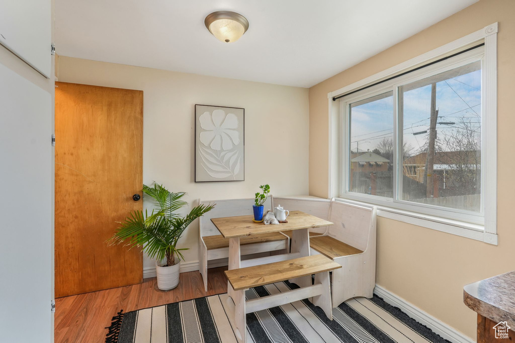 Dining space with baseboards and wood finished floors