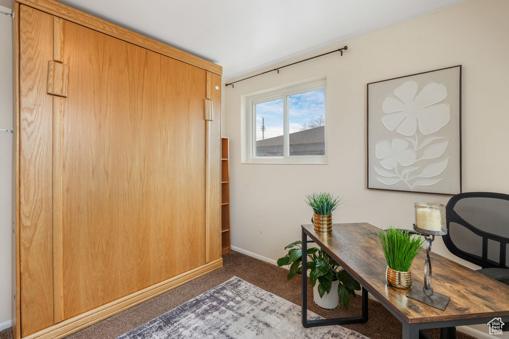 Office area with baseboards and carpet