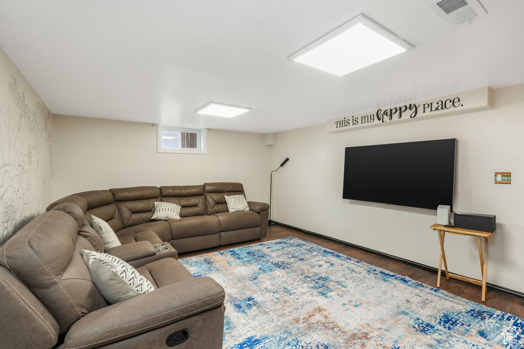 Living area featuring wood finished floors and visible vents