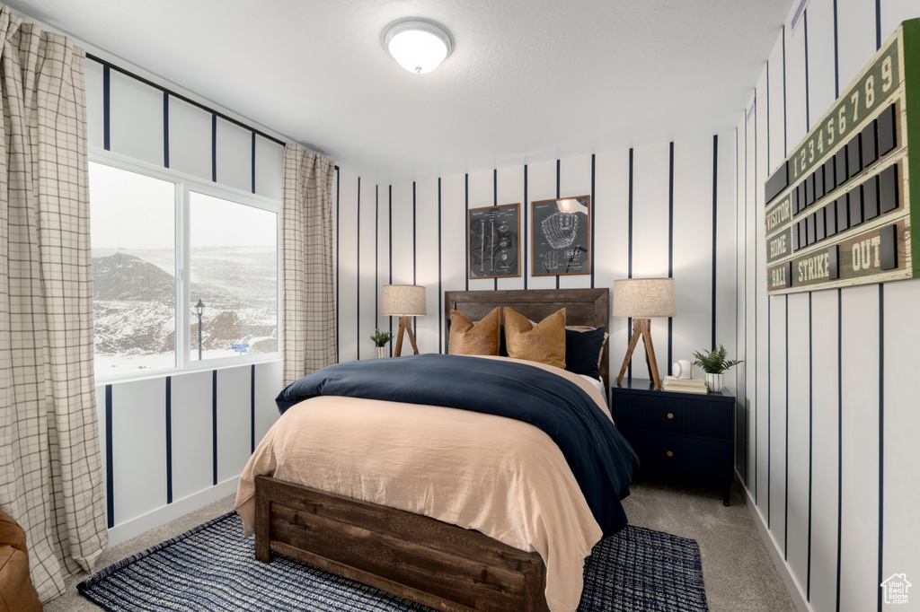 Carpeted bedroom featuring baseboards and a mountain view