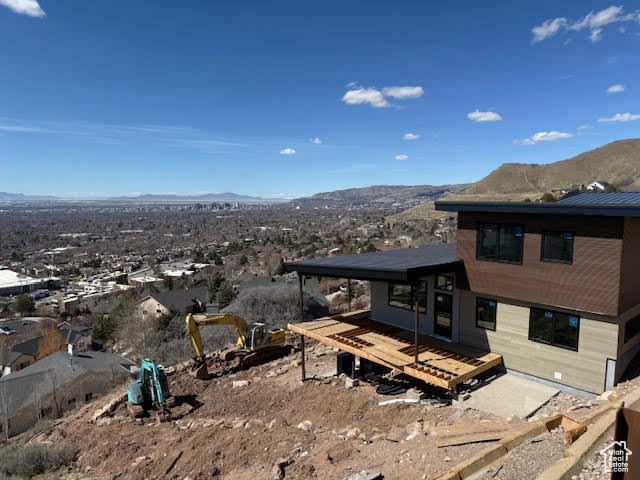 Back of property with a deck with mountain view