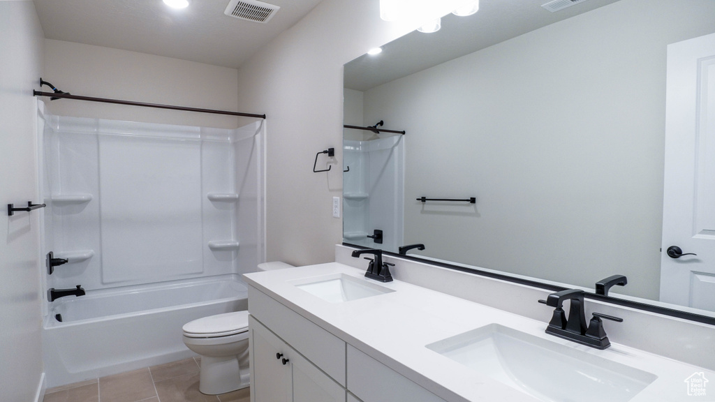 Full bathroom with a sink, visible vents, toilet, and tile patterned floors