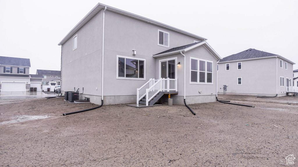 Back of house with central air condition unit