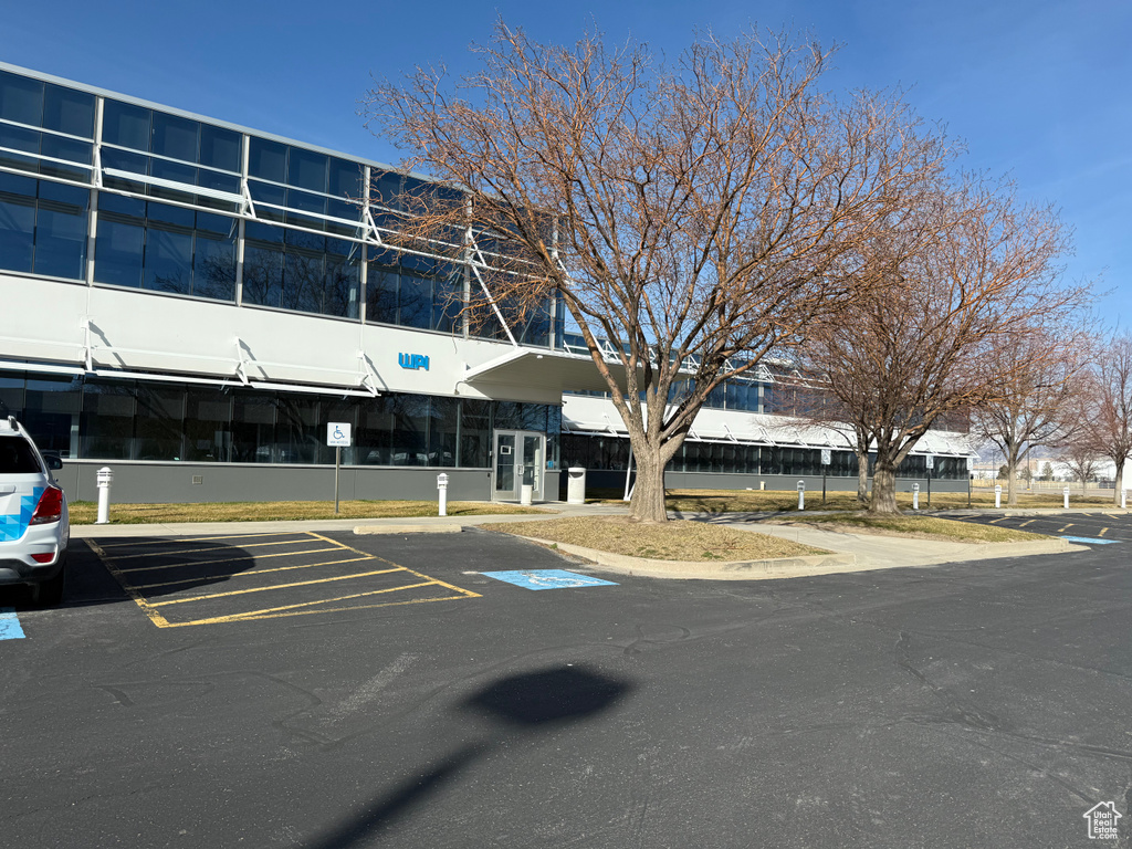 View of building exterior with uncovered parking