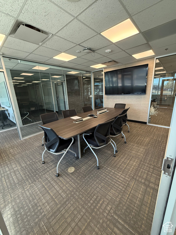 Carpeted office space with a drop ceiling