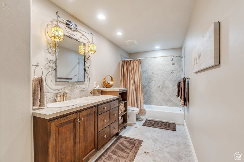 Bathroom with toilet, shower / tub combo with curtain, vanity, baseboards, and recessed lighting