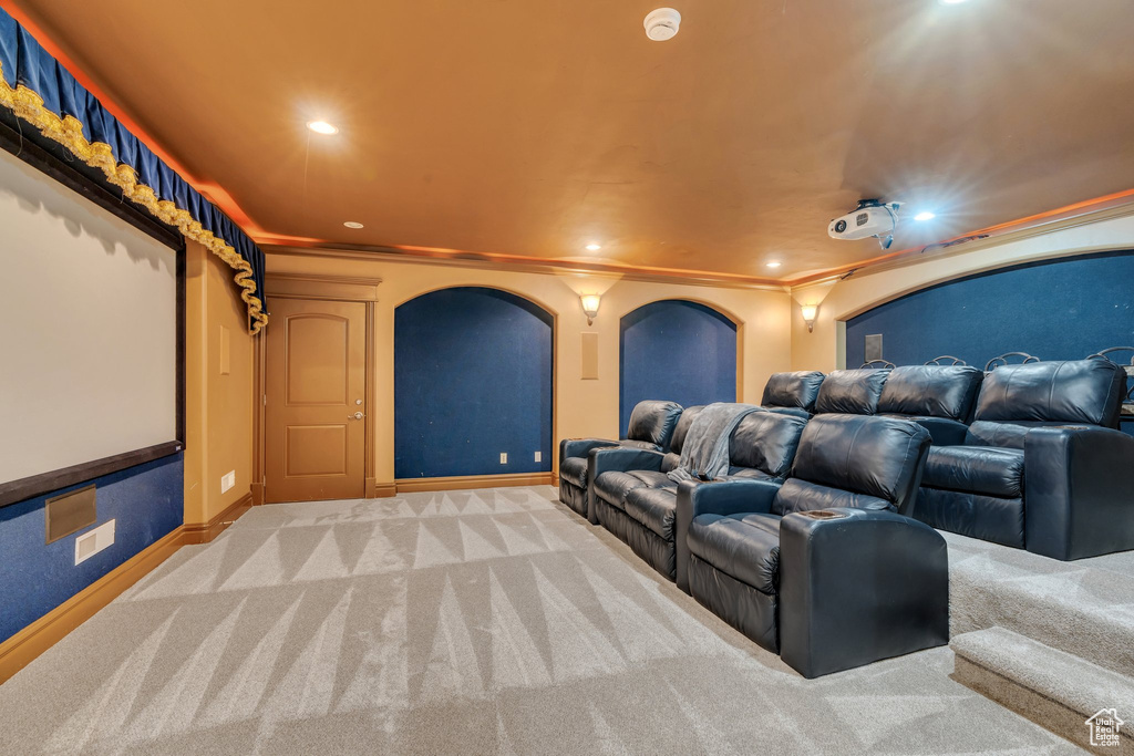 Home theater featuring baseboards, carpet flooring, ornamental molding, and recessed lighting