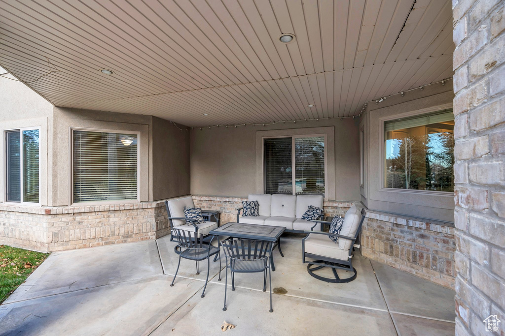 View of patio with an outdoor hangout area