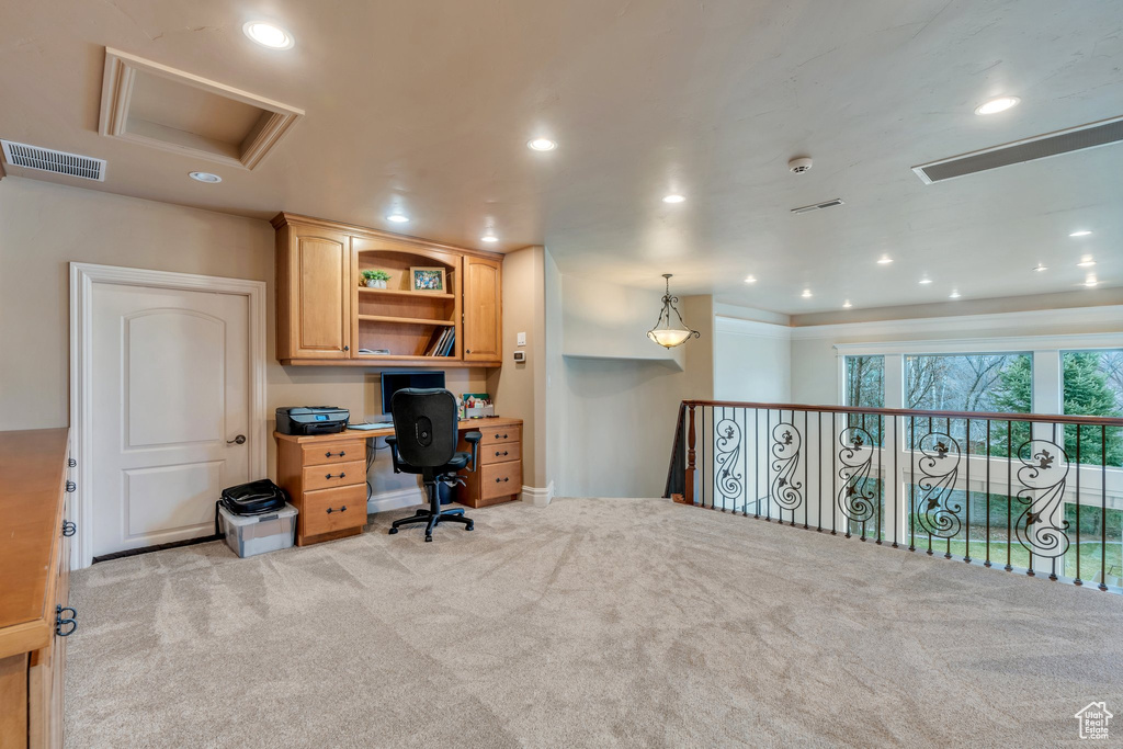 Carpeted office featuring visible vents, recessed lighting, and attic access