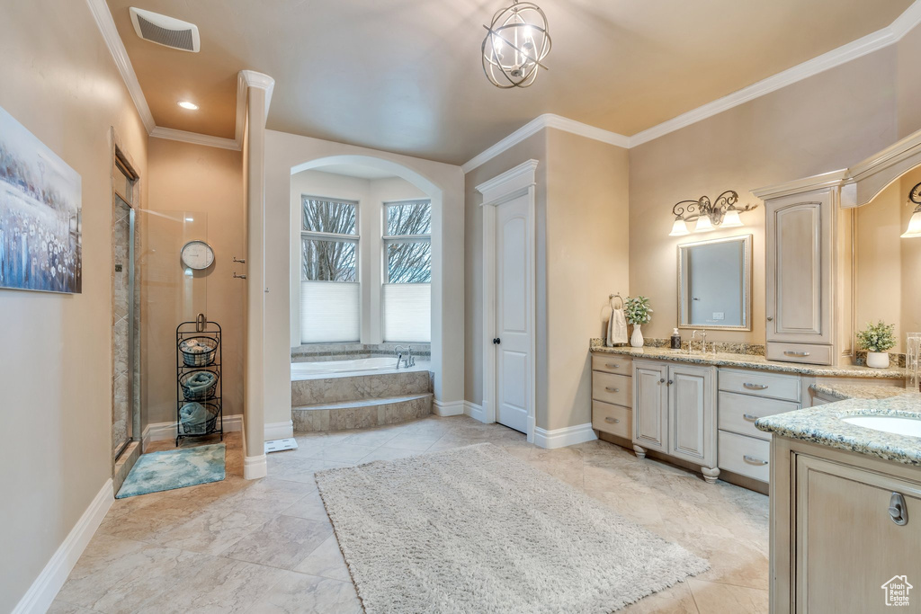 Full bath with baseboards, crown molding, a garden tub, and vanity