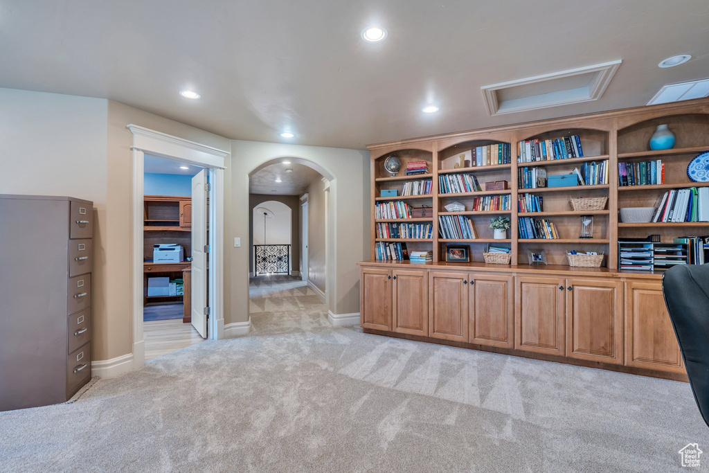 Unfurnished room featuring arched walkways, light colored carpet, and recessed lighting