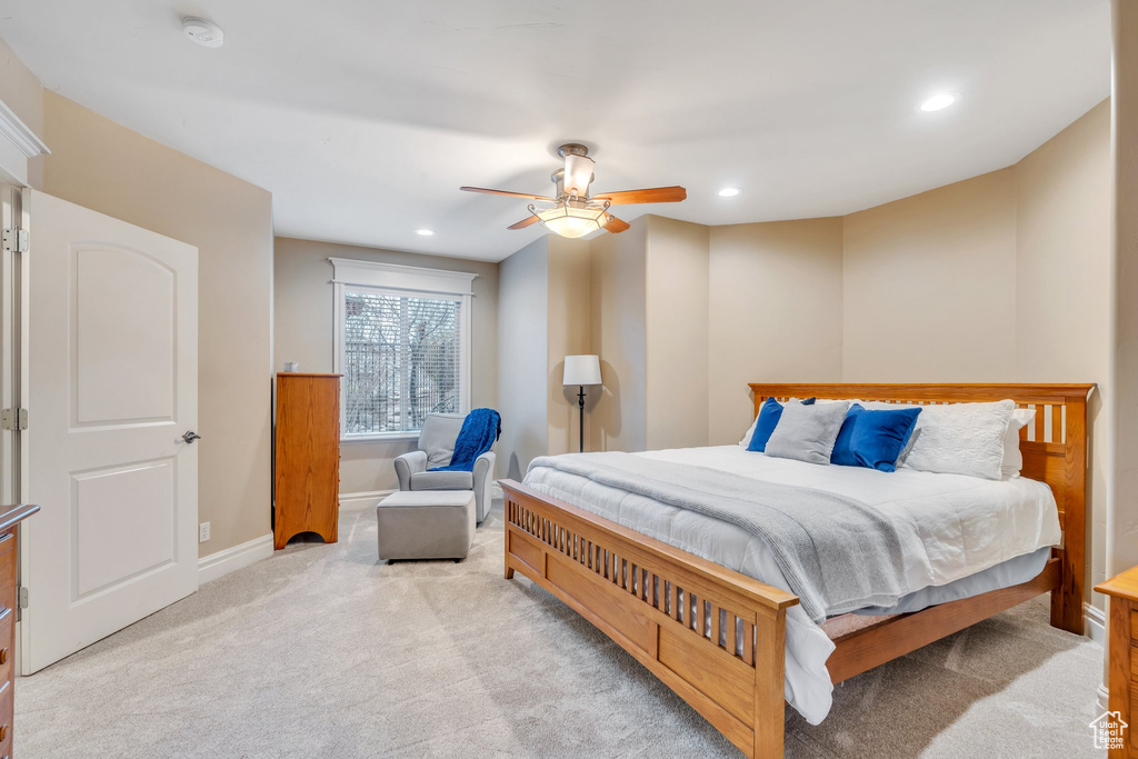 Bedroom featuring baseboards, recessed lighting, a ceiling fan, and light colored carpet
