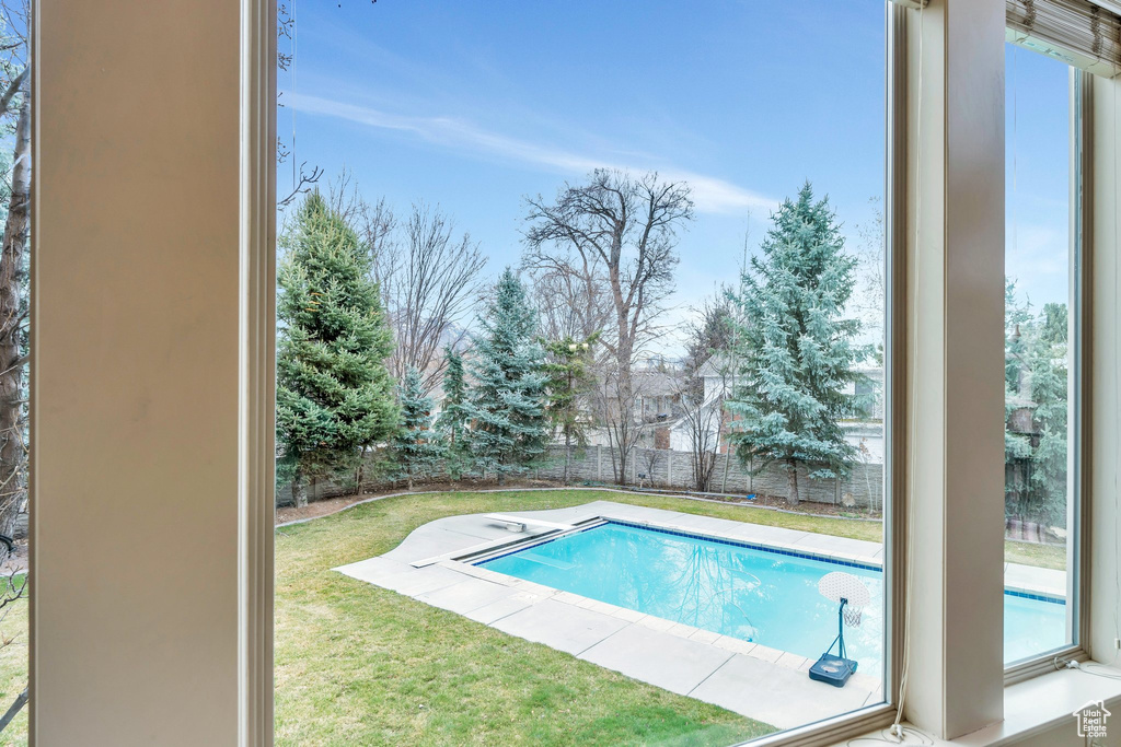 Outdoor pool featuring a fenced backyard and a yard