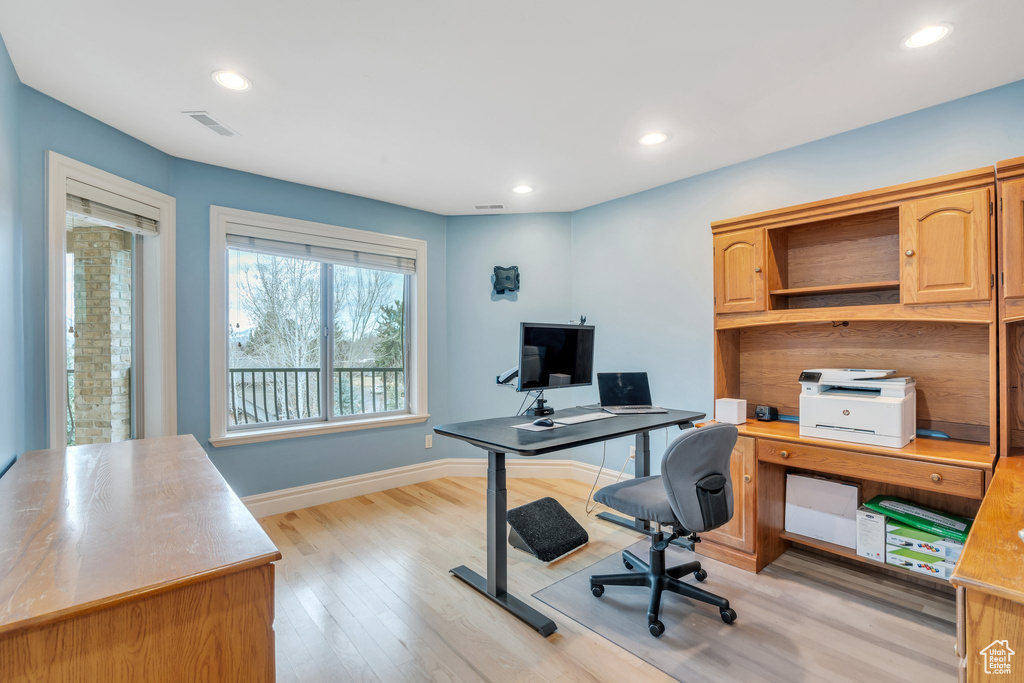 Office featuring visible vents, baseboards, light wood finished floors, and recessed lighting