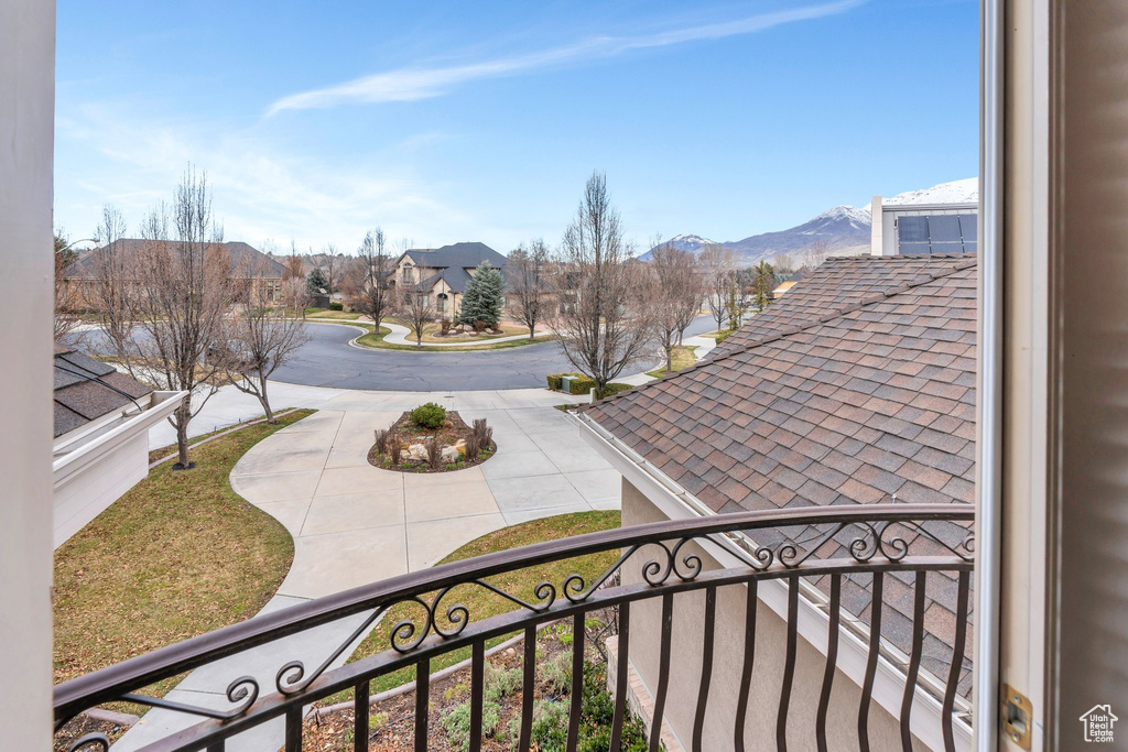View of patio featuring a balcony, a mountain view, and a residential view
