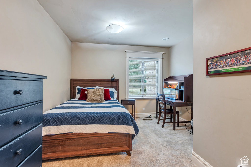 Bedroom with baseboards and carpet