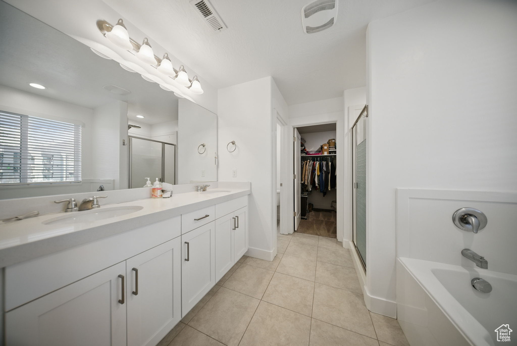 Bathroom featuring visible vents, a sink, tile patterned flooring, and a shower stall