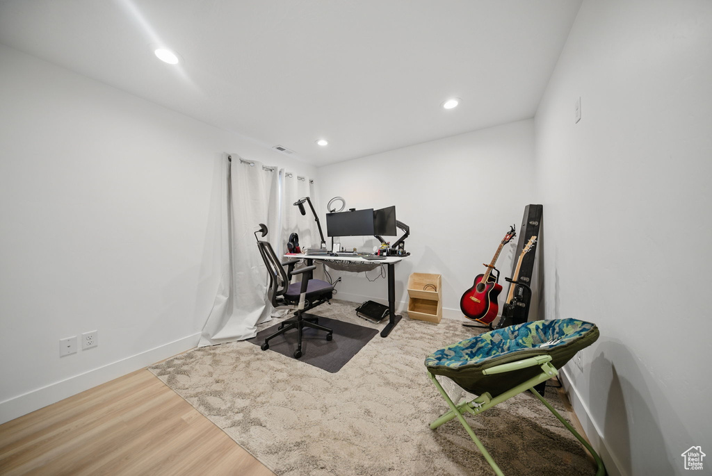 Office space with baseboards, wood finished floors, and recessed lighting