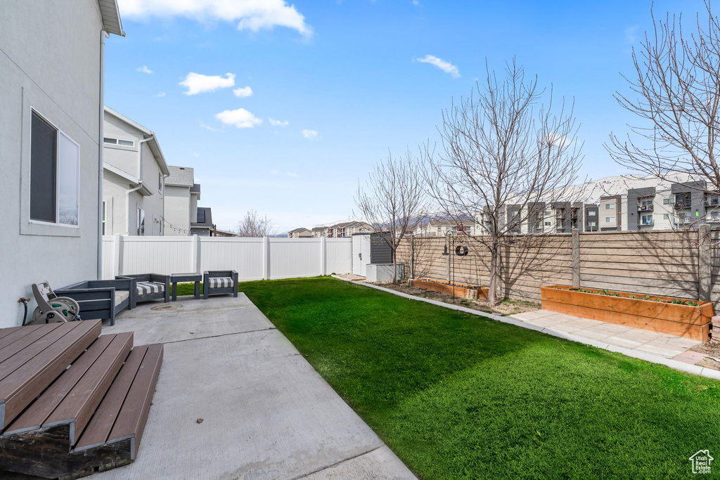 View of yard with a patio, a fenced backyard, a residential view, a garden, and outdoor lounge area